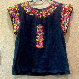 Women’s black top with bright colored embroidered accents